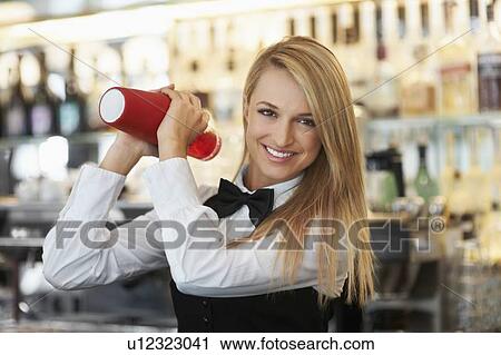 Young female bartender using cocktail shaker View Large Photo Image Stock Image - Young female bartender using cocktail shaker. Fotosearch