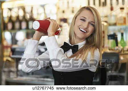 Young female bartender using cocktail shaker View Large Photo Image Stock Photography - Young female bartender using cocktail shaker. Fotosearch