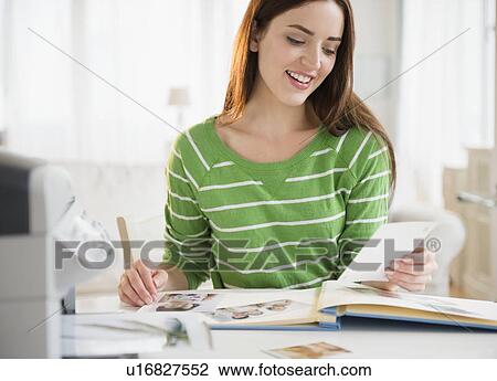 Stock Image - Young woman counting bills. Fotosearch