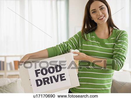 Young woman holding carton box View Large Photo Image Stock Image - Young woman holding carton box. Fotosearch