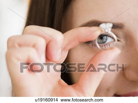 Picture - Young woman holding engagement ring. Fotosearch