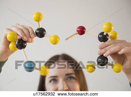 Young woman holding molecules model View Large Photo Image Stock Image - Young woman holding molecules model. Fotosearch