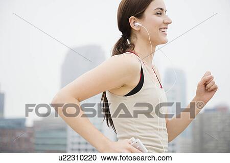 Young woman jogging View Large Photo Image Stock Image - Young woman jogging. Fotosearch