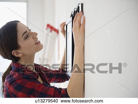 Young woman redecorating room View Large Photo Image Stock Image - Young woman redecorating room. Fotosearch
