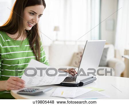 Stock Photo - Young woman using laptop. Fotosearch