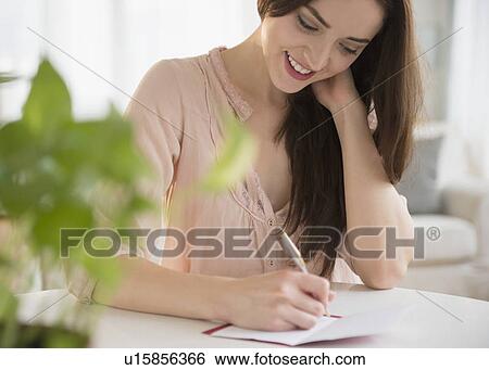 Stock Photograph - Young woman writing letter. Fotosearch