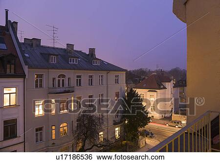 Apartment buildings lit up at night View Large Photo Image Stock Photograph - Apartment buildings lit up at night. Fotosearch