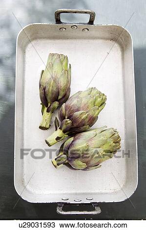 Stock Image - Artichokes in tray. Fotosearch