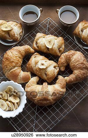 Baked pastries with banana and coffee View Large Photo Image Stock Photograph - Baked pastries with banana and coffee. Fotosearch
