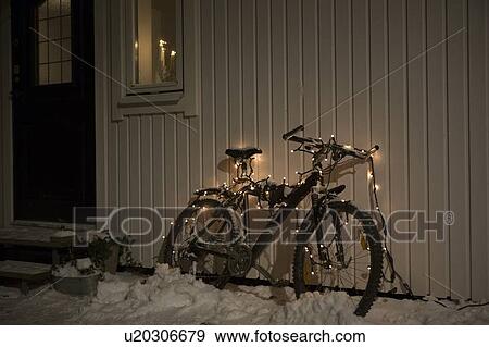 Bicycle with fairy lights in snow View Large Photo Image Stock Photo - Bicycle with fairy lights in snow. Fotosearch