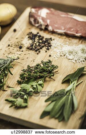 Board laid with meat and seasonings View Large Photo Image Stock Photo - Board laid with meat and seasonings. Fotosearch
