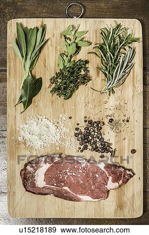 Board laid with meat and seasonings View Large Photo Image Stock Photo - Board laid with meat and seasonings. Fotosearch