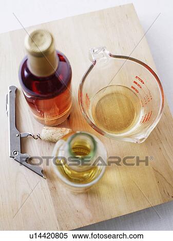 Stock Photography - Board with wine, oil and corkscrew. Fotosearch