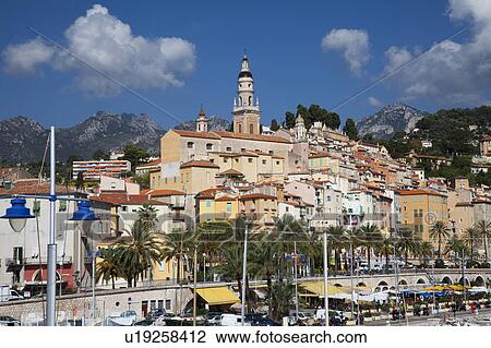 Stock Image - Boats parked in urban harbor. Fotosearch