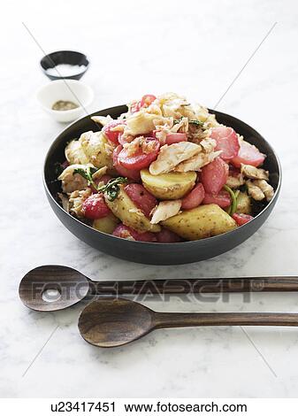 Stock Image - Bowl of radish and salmon salad. Fotosearch