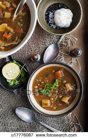 Bowl of stew with garlic and lemon View Large Photo Image Stock Photo - Bowl of stew with garlic and lemon. Fotosearch