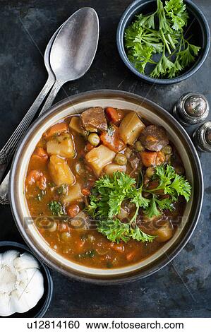 Stock Image - Bowl of stew with herbs. Fotosearch