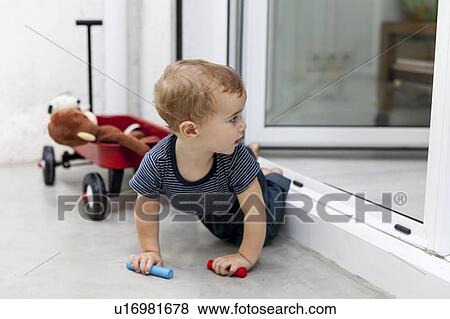 Boy crawling out back door View Large Photo Image Stock Photo - Boy crawling out back door. Fotosearch
