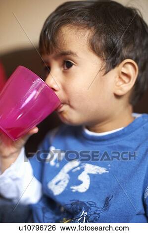 Boy drinking from plastic cup View Large Photo Image Stock Photograph - Boy drinking from plastic cup. Fotosearch