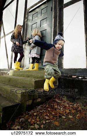 Boy jumping from doorstep View Large Photo Image Stock Image - Boy jumping from doorstep. Fotosearch