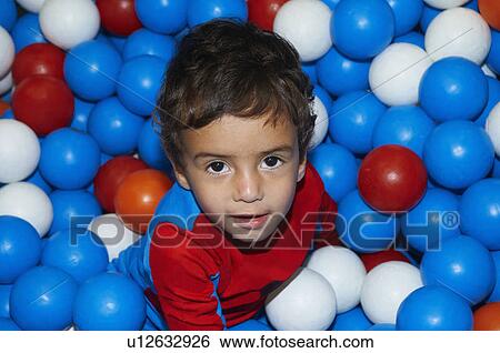 Boy playing in ball pit View Large Photo Image Stock Photograph - Boy playing in ball pit. Fotosearch