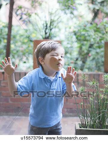 Boy pressing face against glass View Large Photo Image Picture - Boy pressing face against glass. Fotosearch
