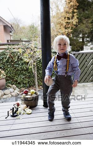 Boy wearing suspenders and bow tie View Large Photo Image Stock Photography - Boy wearing suspenders and bow tie. Fotosearch