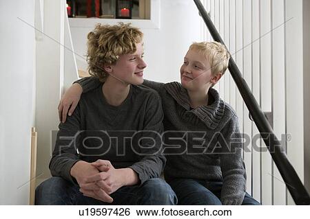 Boys sitting on stairs together View Large Photo Image Stock Photograph - Boys sitting on stairs together. Fotosearch
