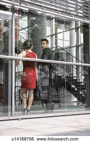 Business people standing by window View Large Photo Image Stock Photograph - Business people standing by window. Fotosearch