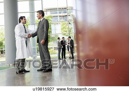 Businessman and doctor shaking hands View Large Photo Image Stock Photo - Businessman and doctor shaking hands. Fotosearch