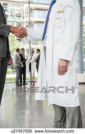 Businessman and doctor shaking hands View Large Photo Image Stock Photography - Businessman and doctor shaking hands. Fotosearch
