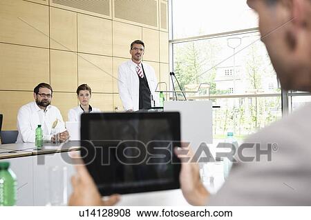 Stock Photo - Businessman using tablet computer. Fotosearch