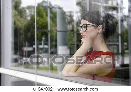 Stock Image - Businesswoman looking out window. Fotosearch