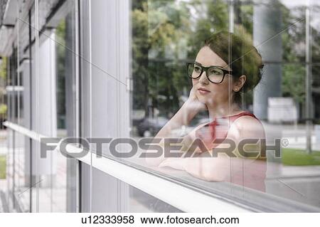 Stock Photo - Businesswoman looking out window. Fotosearch