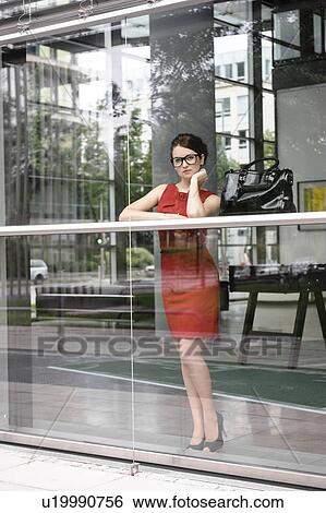 Stock Photograph - Businesswoman looking out window. Fotosearch