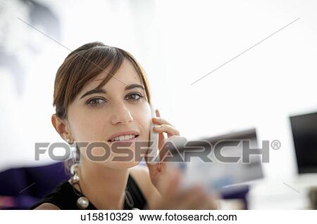 Businesswoman shopping on phone View Large Photo Image Stock Photo - Businesswoman shopping on phone. Fotosearch