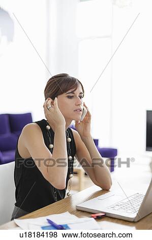 Businesswoman talking on cell phone View Large Photo Image Stock Photo - Businesswoman talking on cell phone. Fotosearch