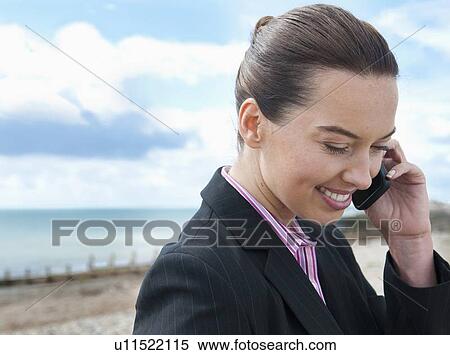 Businesswoman talking on cell phone View Large Photo Image Stock Photography - Businesswoman talking on cell phone. Fotosearch