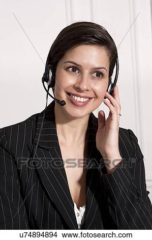 Picture - Businesswoman talking on headset. Fotosearch