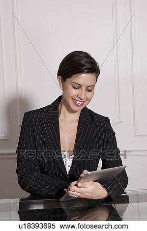 Businesswoman using tablet computer View Large Photo Image Stock Photography - Businesswoman using tablet computer. Fotosearch