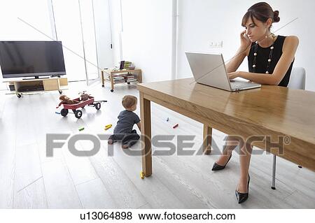 Stock Photo - Businesswoman working at home. Fotosearch