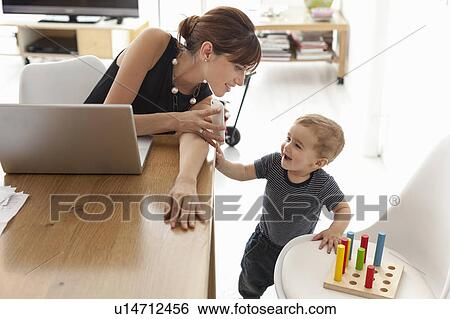 Businesswoman working at home View Large Photo Image Stock Photograph - Businesswoman working at home. Fotosearch