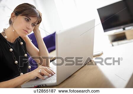 Businesswoman working on laptop View Large Photo Image Stock Photo - Businesswoman working on laptop. Fotosearch