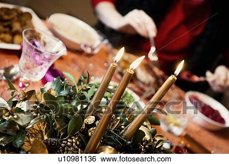 Stock Photograph - Candles burning in centerpiece. Fotosearch