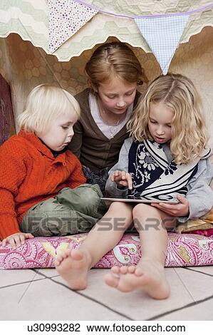 Children using tablet computer in fort View Large Photo Image Stock Image - Children using tablet computer in fort. Fotosearch