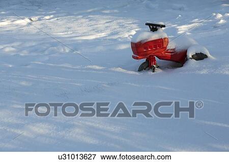 Stock Photo - Childs toy in snow-covered field. Fotosearch