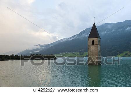 Stock Photo - Clock tower submerged in rural lake. Fotosearch