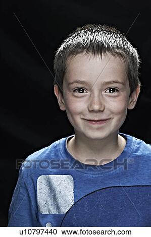 Stock Image - Close up of boys smiling face. Fotosearch