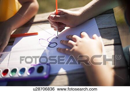 Close up of children painting outdoors View Large Photo Image Stock Photograph - Close up of children painting outdoors. Fotosearch