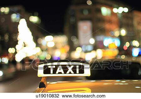 Close up of illuminated taxi sign View Large Photo Image Stock Image - Close up of illuminated taxi sign. Fotosearch
